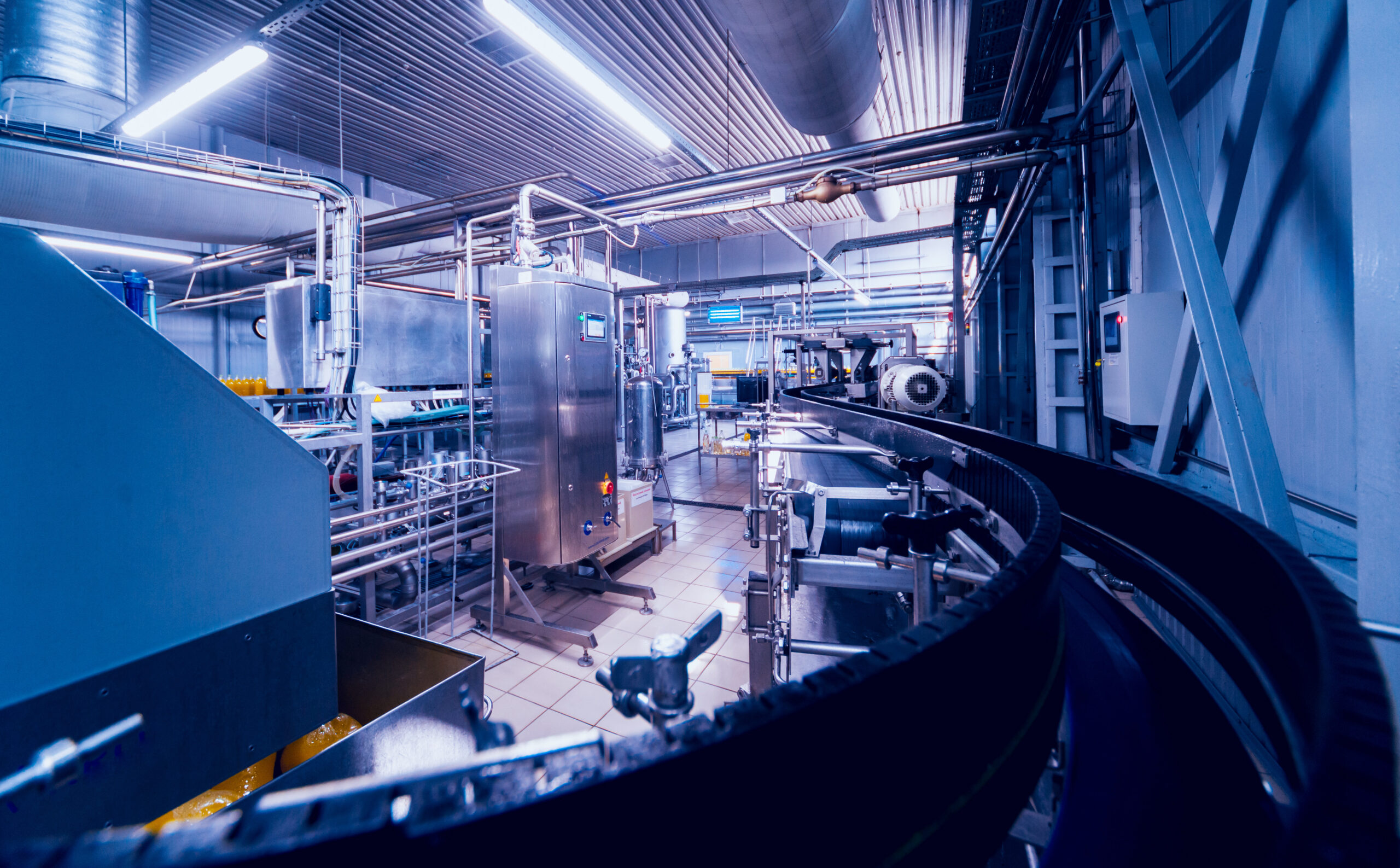 Beverage,factory,interior.,conveyor,with,bottles,for,juice,or,water.